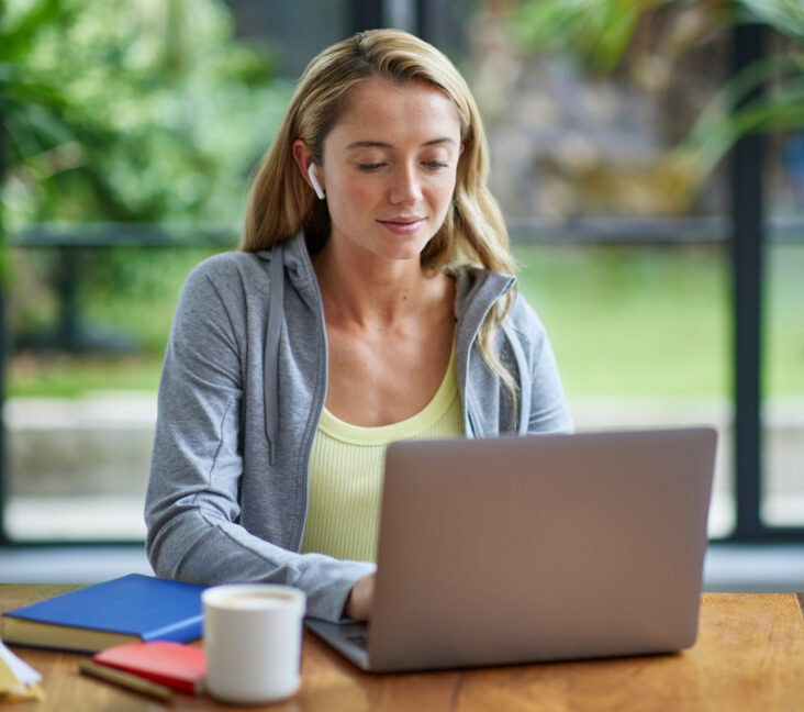 Person sitting at a table using a laptop